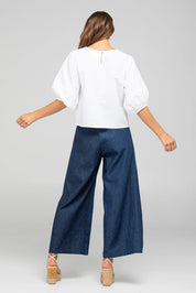A model wearing the Ria Denim Pant in colour Darkdenim (Blue), from the back