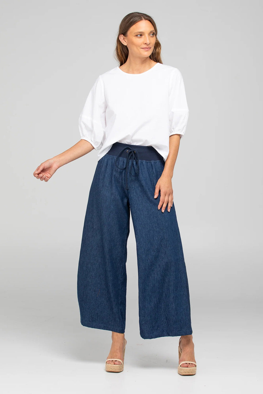 A model wearing the Ria Denim Pant in colour Darkdenim (Blue), from the front, showing the whole outfit