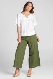 A model wearing the Ria Pant in colour Khaki (Green), from the front, showing the whole outfit