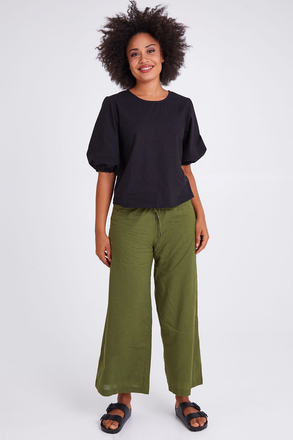 Model Olivia wearing size 10 of the Ria Pant in colour Khaki (Green), from the front, showing the whole outfit