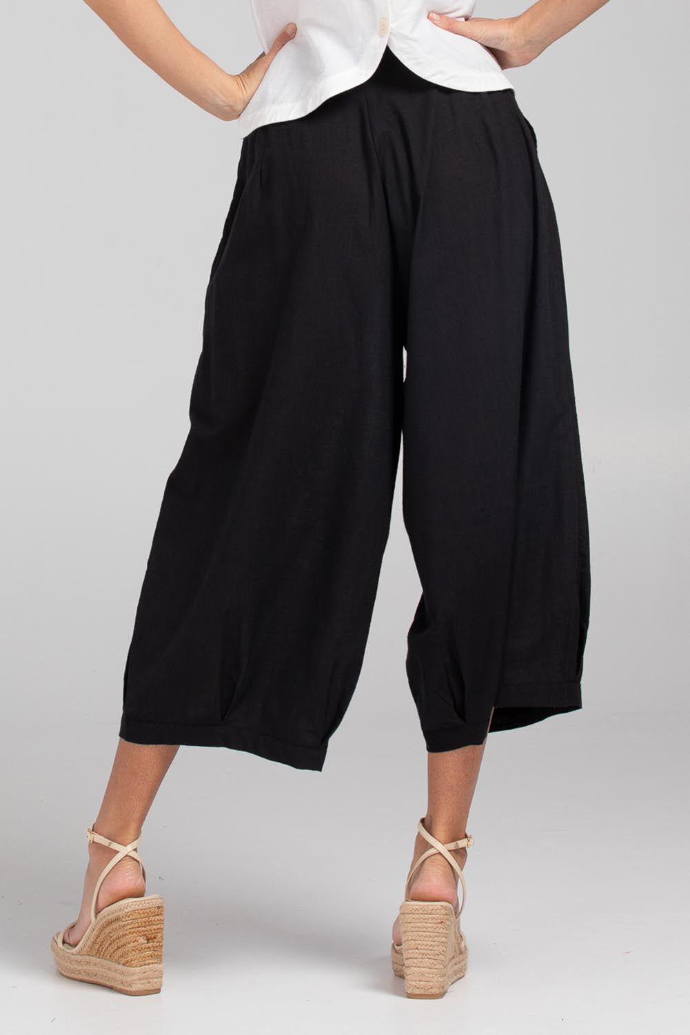 A model wearing the Zetta Cotton Pant in colour Black (Black), from the back