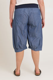 Model Chanel wearing size 16 of the Jada Short in colour Chambray (Blue), from the back