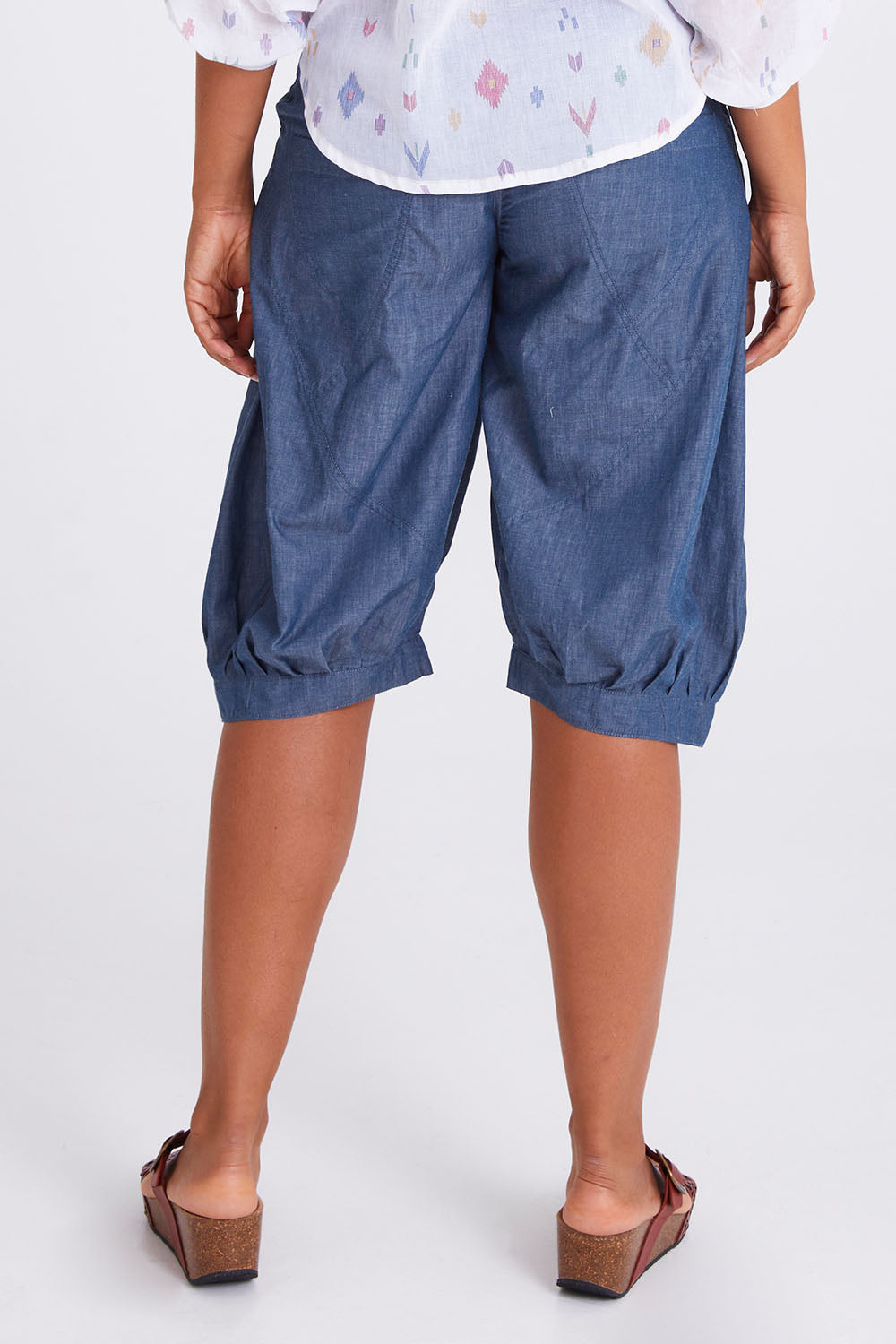 Model Olivia wearing size 10 of the Jada Short in colour Chambray (Blue), from the back