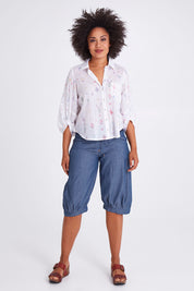Model Olivia wearing size 10 of the Jada Short in colour Chambray (Blue), from the front, showing the whole outfit
