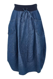 Product shot of the Guru Denim Skirt in colour Middenim (Blue), from the front