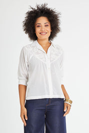 Model Olivia wearing size 10 of the Maahee Shirt in colour White (White), from the front, cropped image