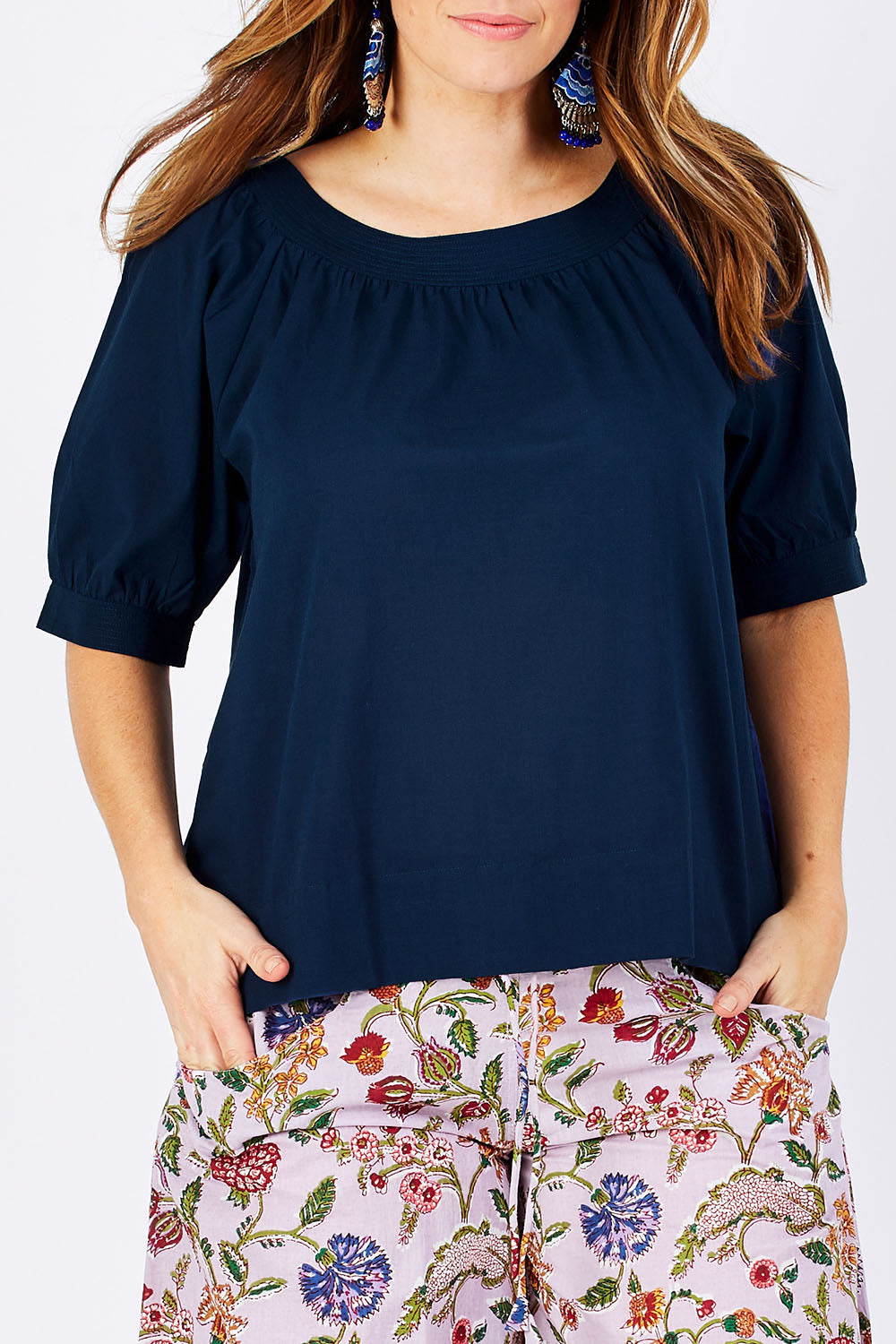 Model Laura wearing size 12 of the Bliss Top Basics in colour BlueBasic (Blue), from the front, cropped image