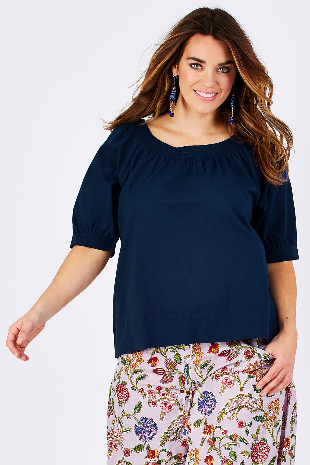 Model Laura wearing size 12 of the Bliss Top Basics in colour BlueBasic (Blue), from the front, cropped image