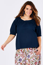 Model Laura wearing size 12 of the Bliss Top Basics in colour BlueBasic (Blue), from the front, cropped image