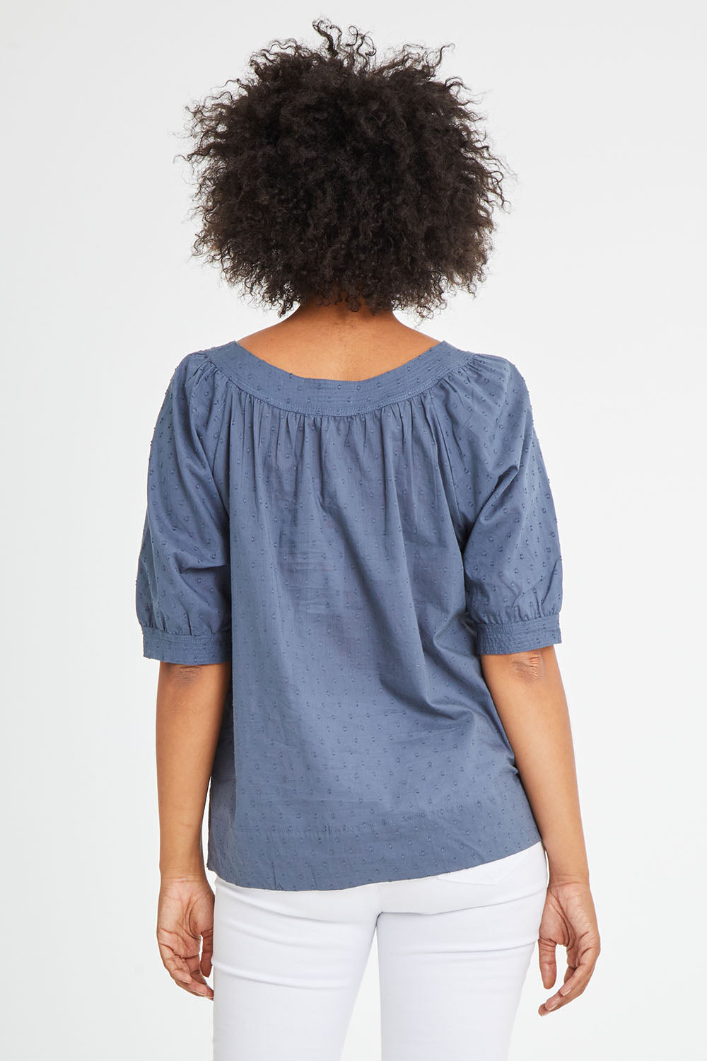 Model Olivia wearing size 10 of the Bliss Top in colour Indiansea (Blue), from the back