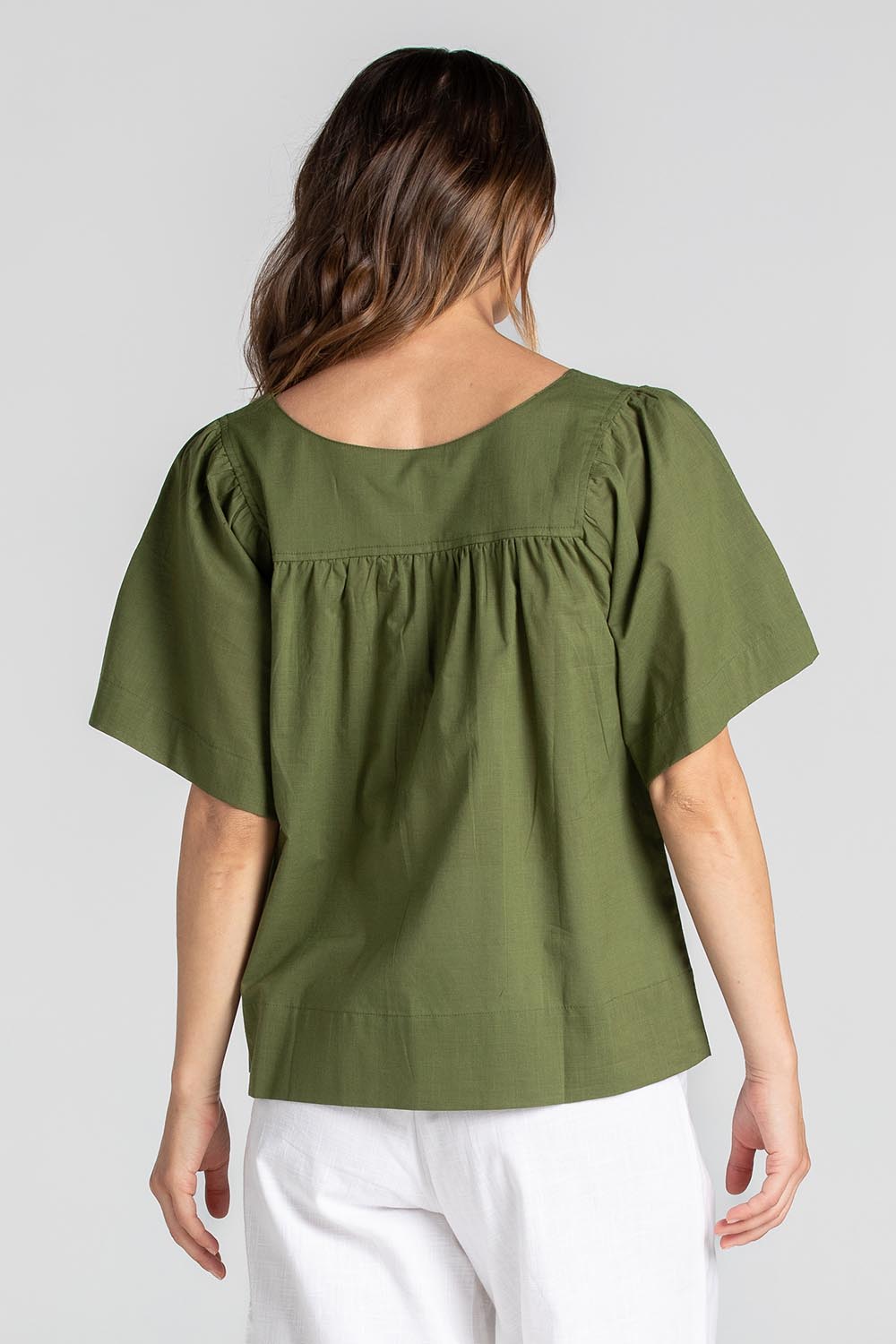 A model wearing the Freya Cotton Top in colour Khaki (Green), from the back