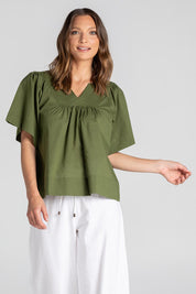 A model wearing the Freya Cotton Top in colour Khaki (Green), from the front, cropped image