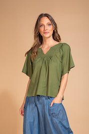 A model wearing the Freya Cotton Top in colour Khaki (Green), from the front, showing the whole outfit