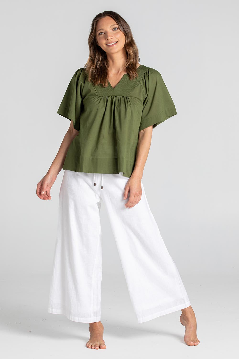 A model wearing the Freya Cotton Top in colour Khaki (Green), from the front, showing the whole outfit