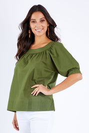 Model Vitoria wearing size 10 of the Bliss Top in colour Khaki (Blue), from the front, cropped image