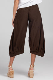 A model wearing the Guru Pant in colour Coffee, from the back
