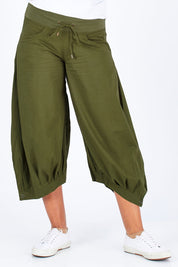 Model Summer wearing size 10 of the Guru Pant in colour Khaki (Green), from the front, cropped image