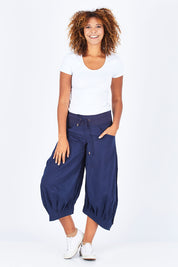 Model Summer wearing size 10 of the Guru Pant in colour Navy (Blue), from the front, showing the whole outfit