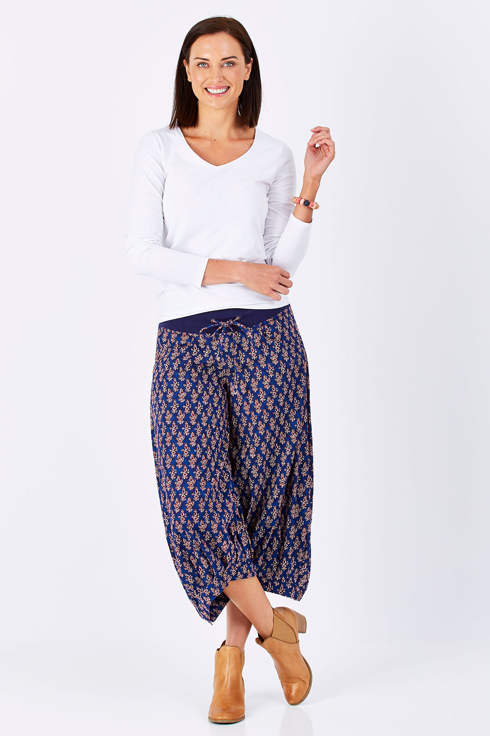 Model Perrie wearing size 10 of the Printed Guru Pants in colour Blue (Blue), from the front, showing the whole outfit