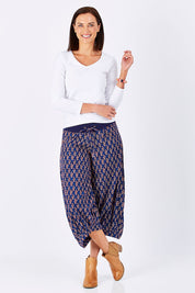 Model Perrie wearing size 10 of the Printed Guru Pants in colour Blue (Blue), from the front, showing the whole outfit