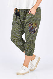 Model Jess wearing size 14 of the Java Pant in colour JuniTile (Green), from the front, cropped image