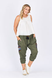 Model Jess wearing size 14 of the Java Pant in colour JuniTile (Green), from the front, showing the whole outfit