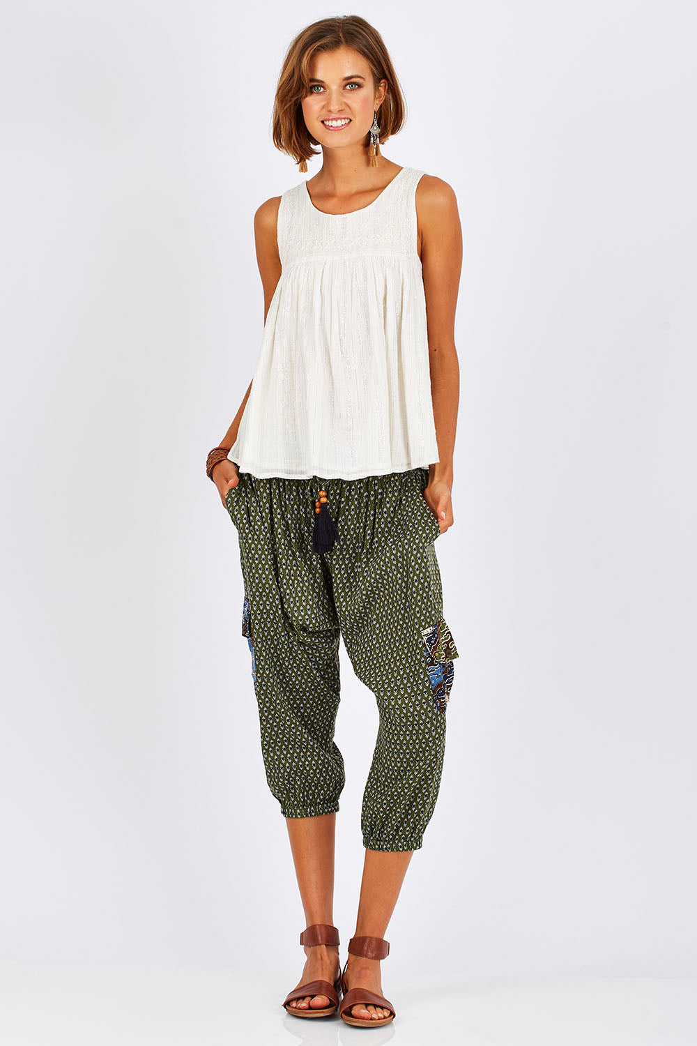 Model Nikki wearing size 10 of the Java Pant in colour JuniTile (Green), from the front, showing the whole outfit