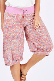 Model Laura wearing size 12 of the Jada Short in colour RoseTile (Pink), from the front, cropped image
