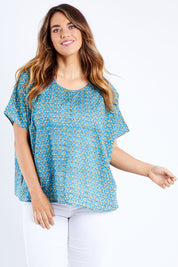 Model Laura wearing size 14 of the Alora Top in colour Bananaflow (Blue), from the front, cropped image