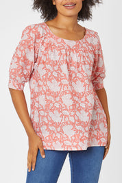Model Olivia wearing size 10 of the Bliss Top in colour Moonga (Pink), from the front, cropped image