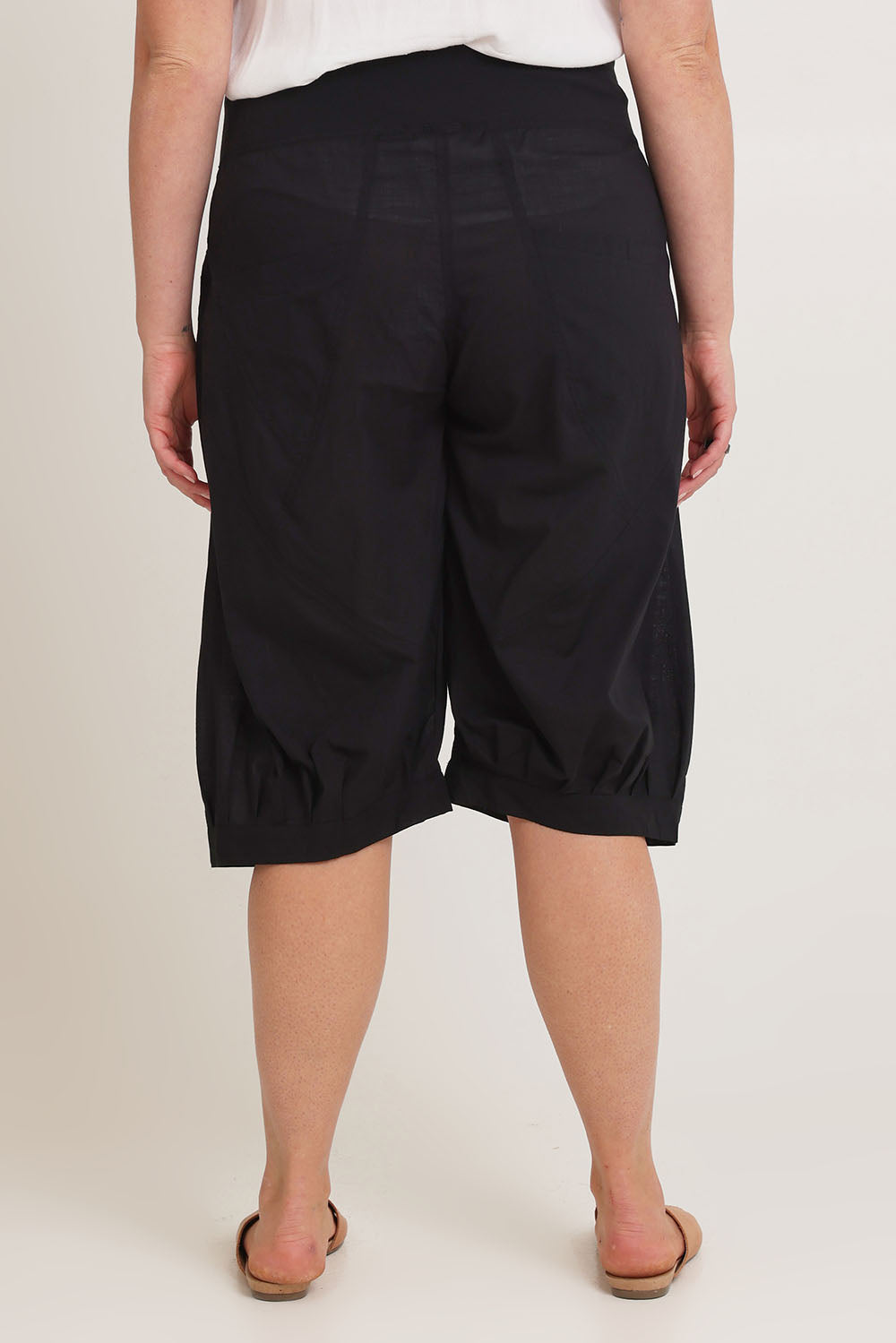 Model Chanel wearing size 16 of the Jada Short in colour Black (Black), from the back