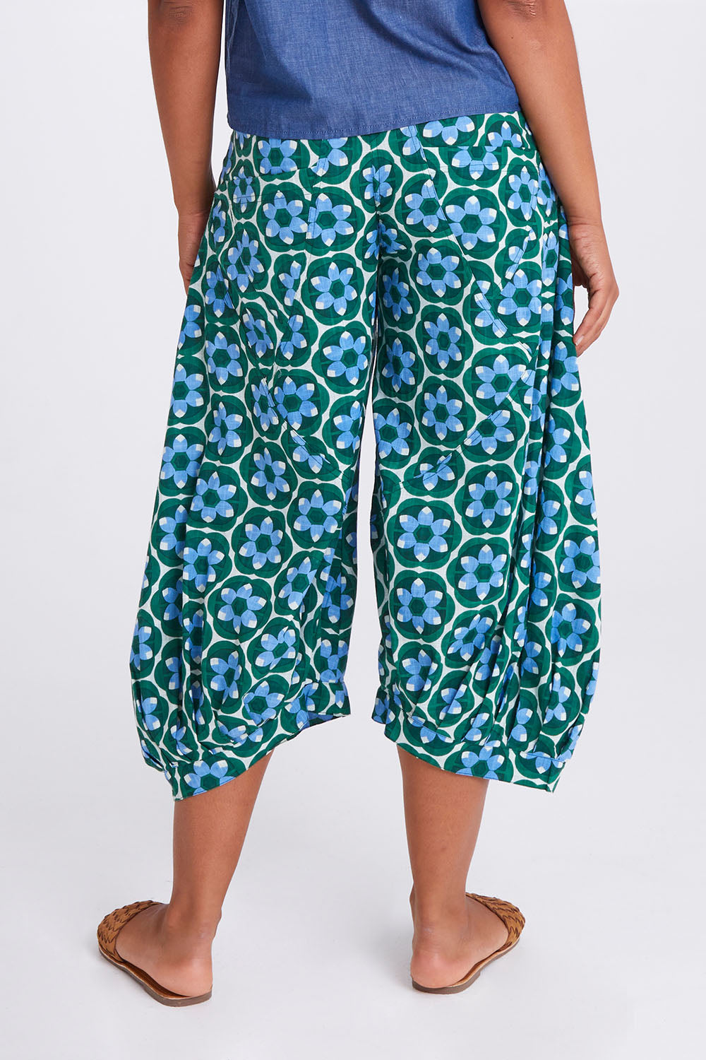 Model Olivia wearing size 10 of the Guru Pant in colour Sorrento (Green), from the back