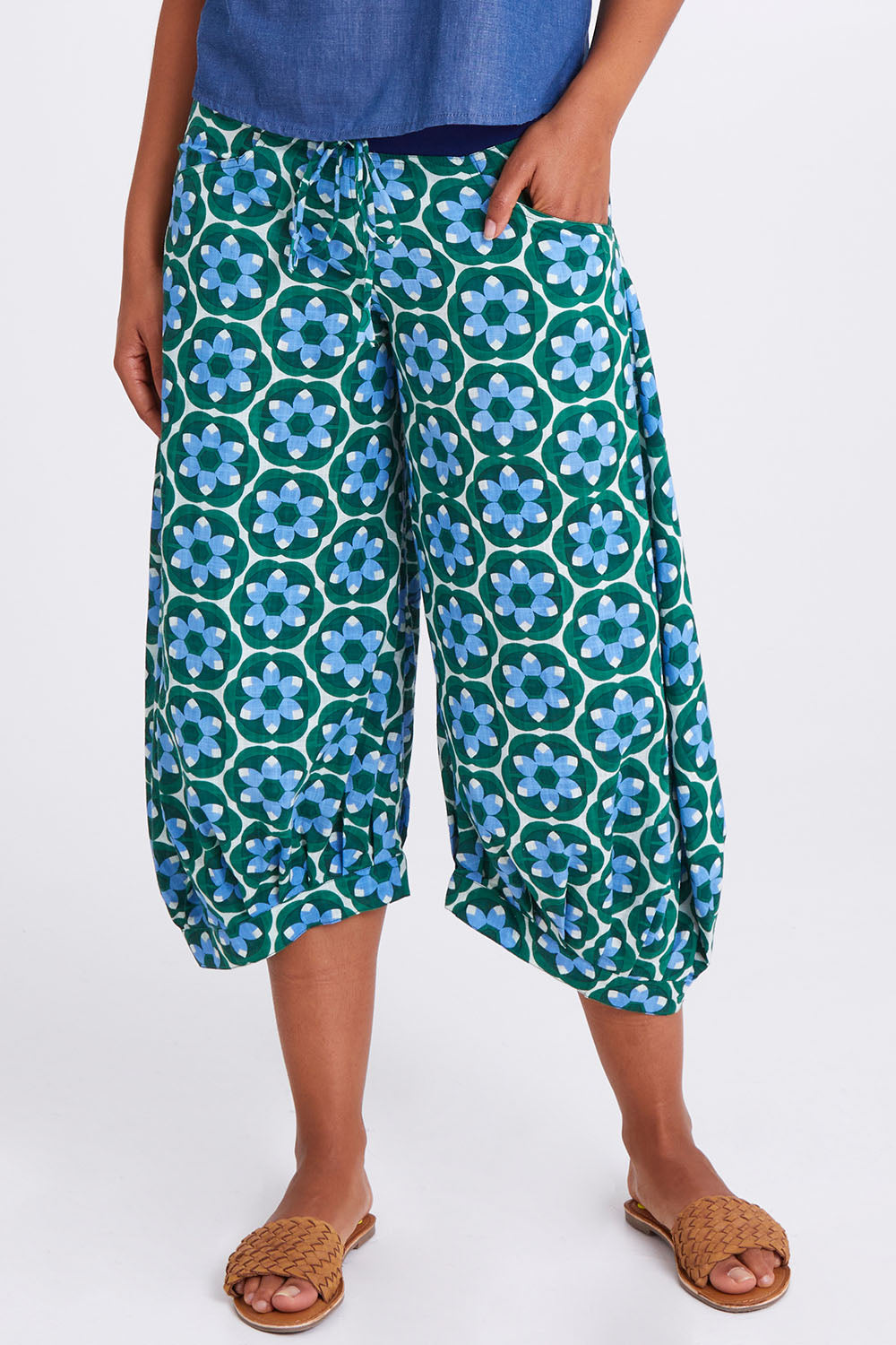 Model Olivia wearing size 10 of the Guru Pant in colour Sorrento (Green), from the front, cropped image