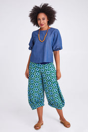Model Olivia wearing size 10 of the Guru Pant in colour Sorrento (Green), from the front, showing the whole outfit