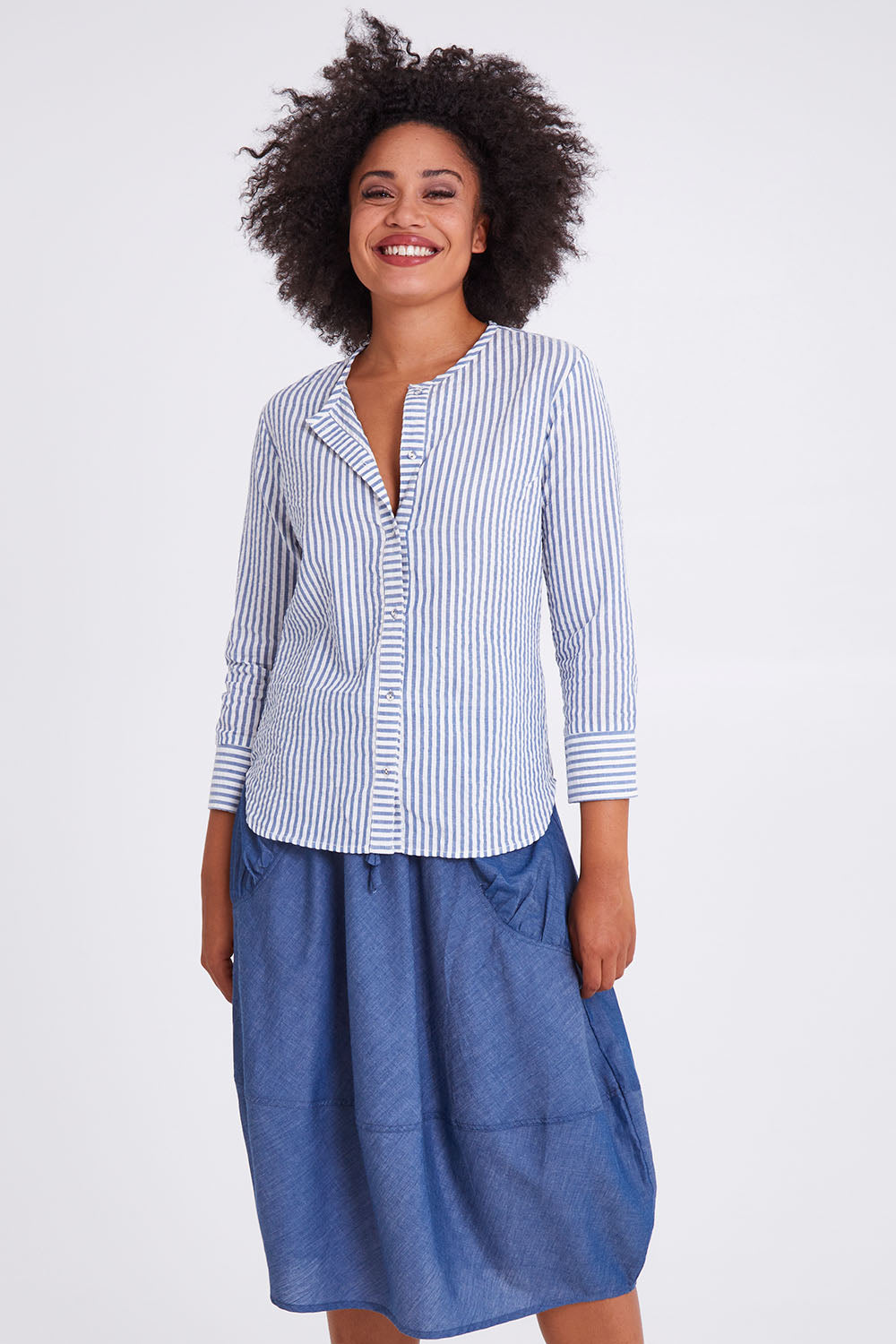 Model Olivia wearing size 10 of the Hazel Shirt in colour Hazelstrip (Blue), from the front, cropped image