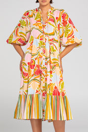 A model wearing the Mabel Cotton Dress in colour Colada (Green), from the front, cropped image