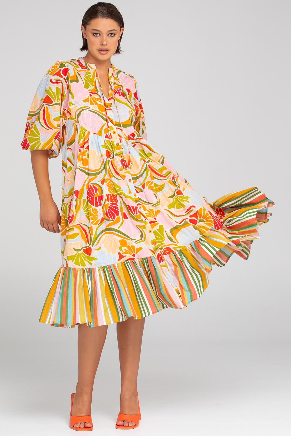 A model wearing the Mabel Cotton Dress in colour Colada (Green), from the front, showing the whole outfit