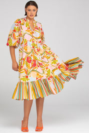 A model wearing the Mabel Cotton Dress in colour Colada (Green), from the front, showing the whole outfit