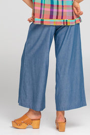 A model wearing the Ria Cotton Pant in colour Chambray (Blue), from the back