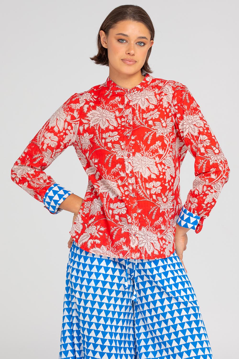 A model wearing the Cove Cotton Shirt in colour Farrah (Red), from the front, cropped image