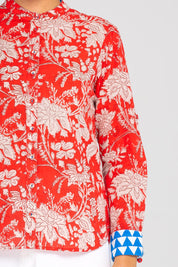 A model wearing the Cove Cotton Shirt in colour Farrah (Red), from the front, cropped image