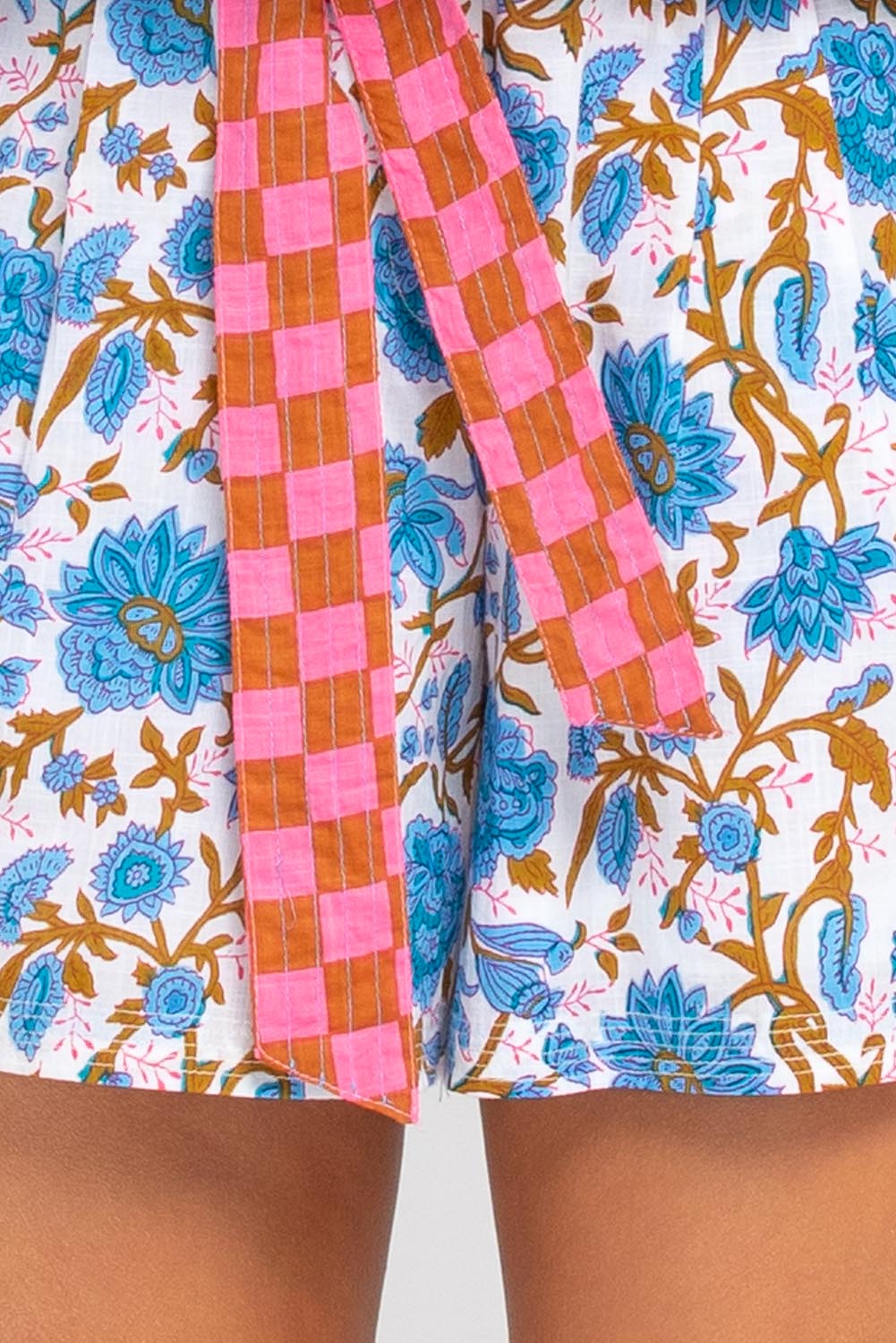 A model wearing the Daisy Cotton Short in colour Splicemaui (Blue), from the front, cropped image