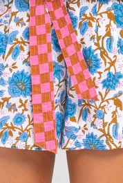 A model wearing the Daisy Cotton Short in colour Splicemaui (Blue), from the front, cropped image