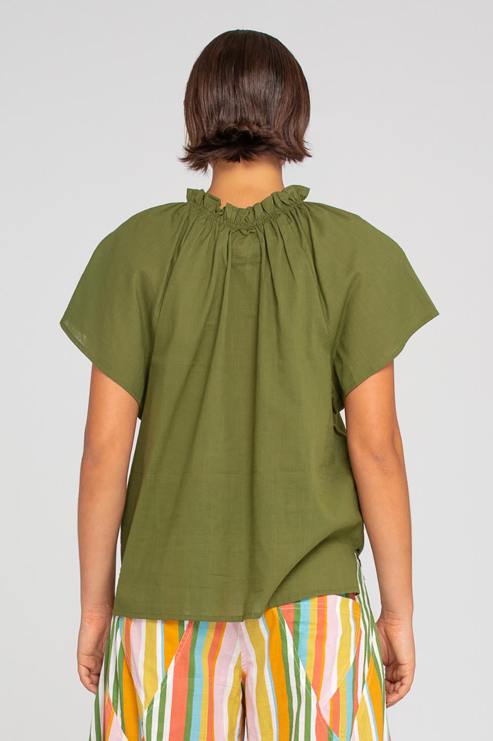 A model wearing the Lilo Cotton Top in colour Khaki (Green), from the back