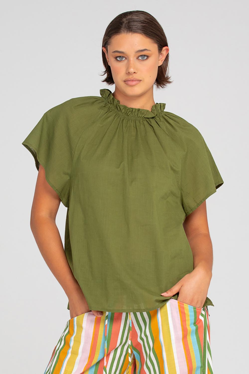 A model wearing the Lilo Cotton Top in colour Khaki (Green), from the front, cropped image