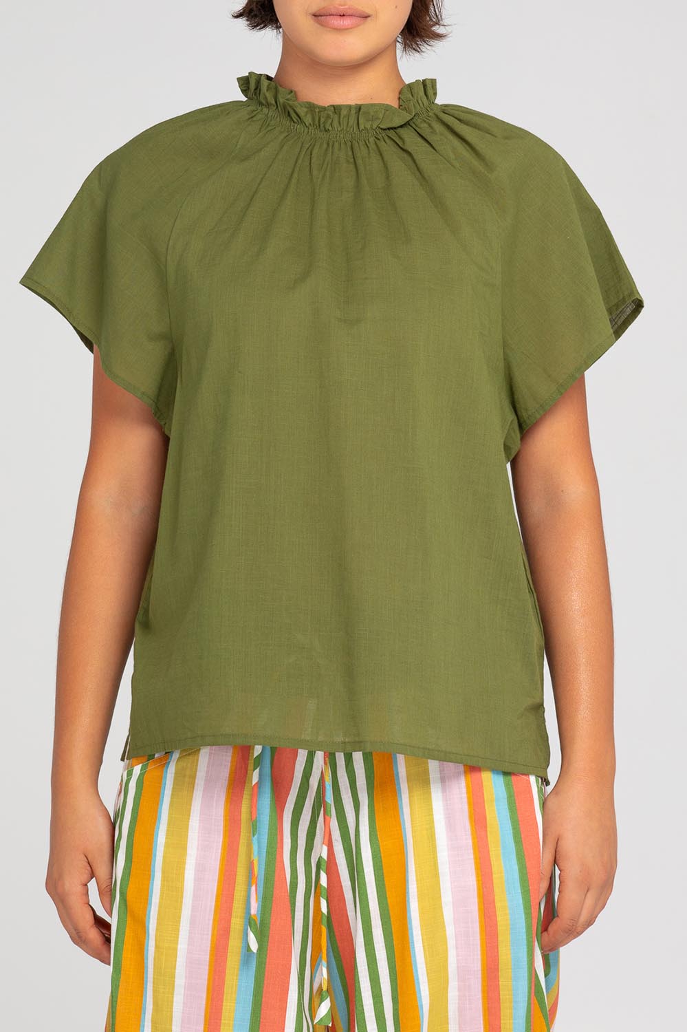 A model wearing the Lilo Cotton Top in colour Khaki (Green), from the front, cropped image