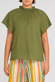 A model wearing the Lilo Cotton Top in colour Khaki (Green), from the front, cropped image