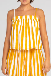 A model wearing the Sami Cotton Singlet in colour Tropical, from the front, cropped image