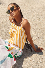 A model wearing the Sami Cotton Singlet in colour Tropical, from the front, showing the whole outfit