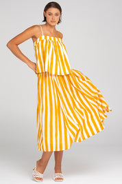 A model wearing the Sami Cotton Singlet in colour Tropical, from the front, showing the whole outfit